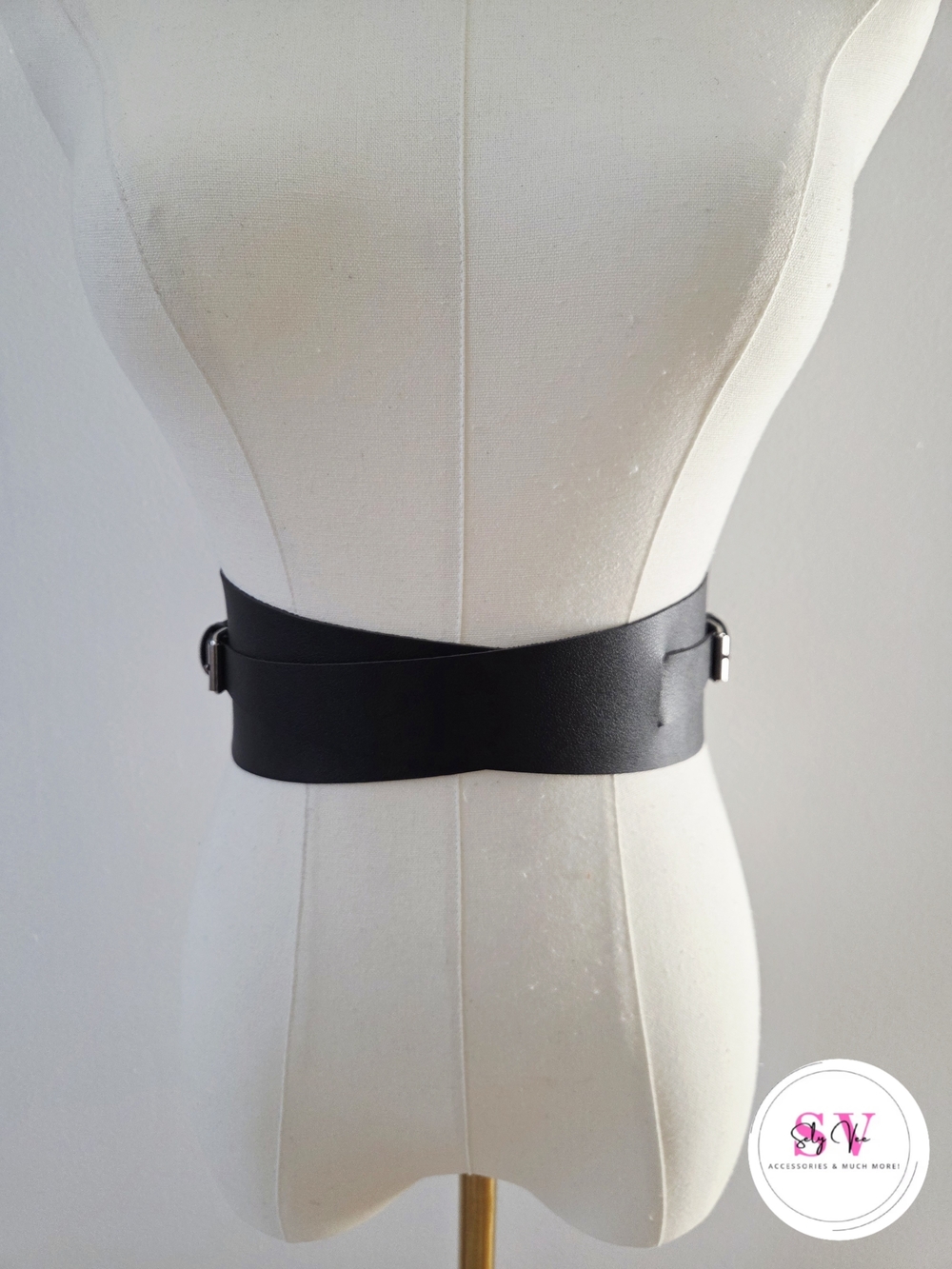 Black faux leather waist belt with silver double buckle.
